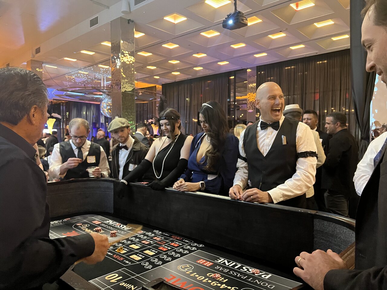 Professional dealers running a roulette table at an Oʻahu casino party