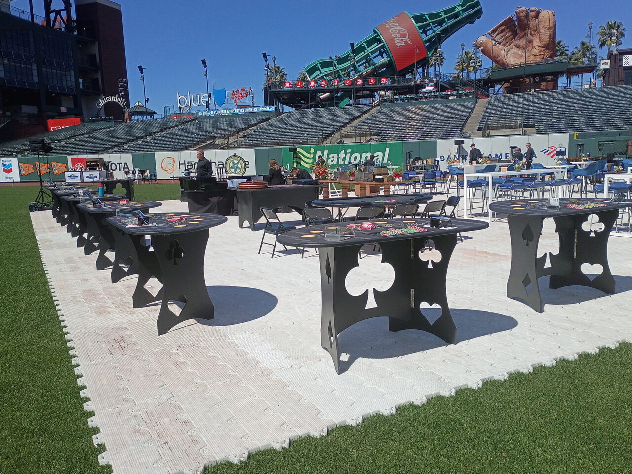 Custom spade and club casino tables set up at an Oʻahu gala venue