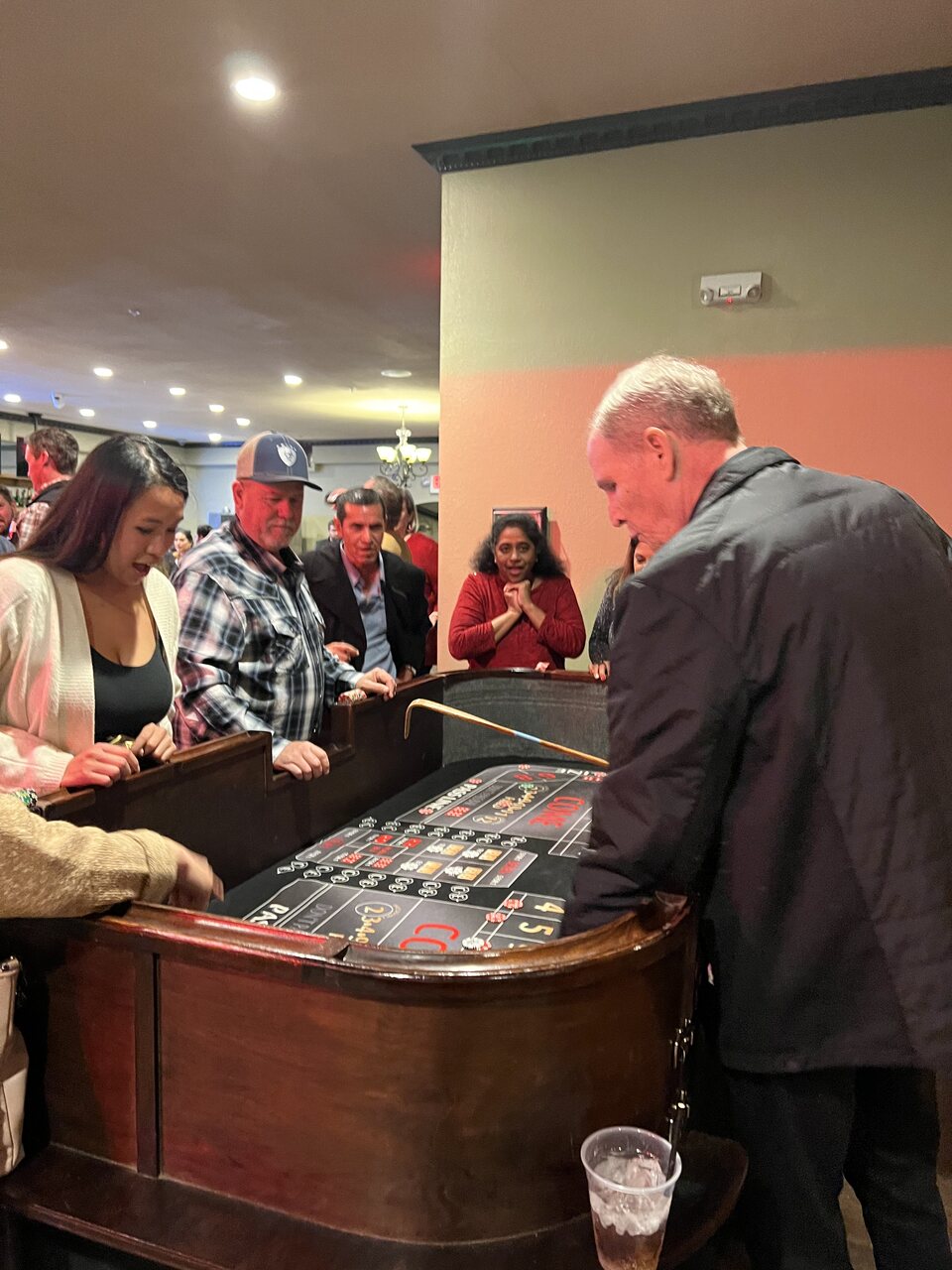 Guests gathered around the roulette wheel at a Honolulu casino party
