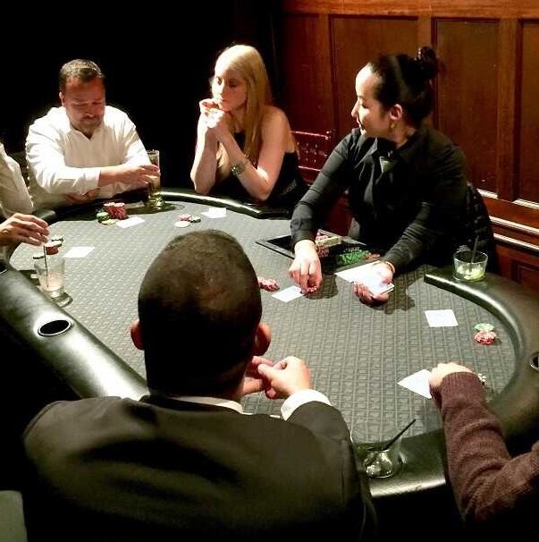 Players enjoying a poker table at an intimate Oʻahu casino party