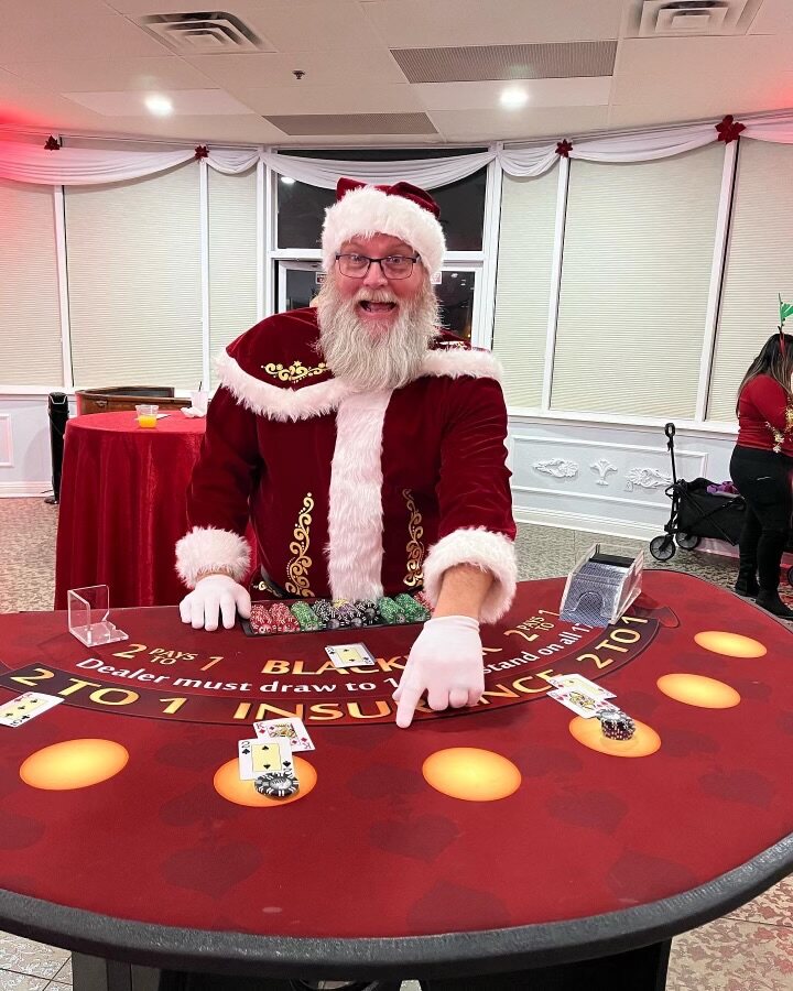 Santa dealing blackjack at a festive holiday casino party in Honolulu