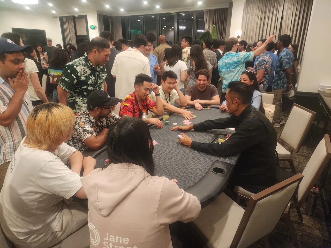 Players at a Texas Hold'em poker table during a Honolulu casino night